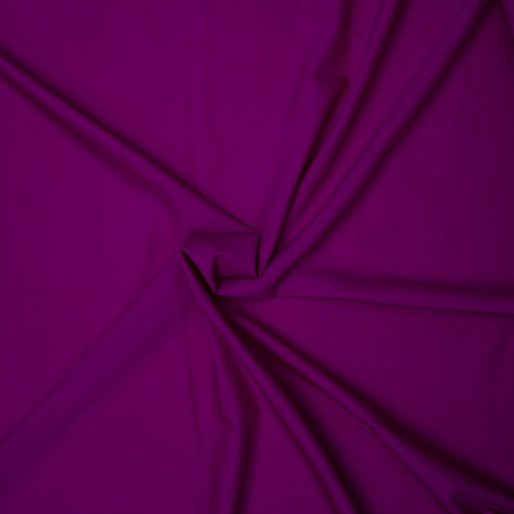 Crimson fabric with pleats converging in the center